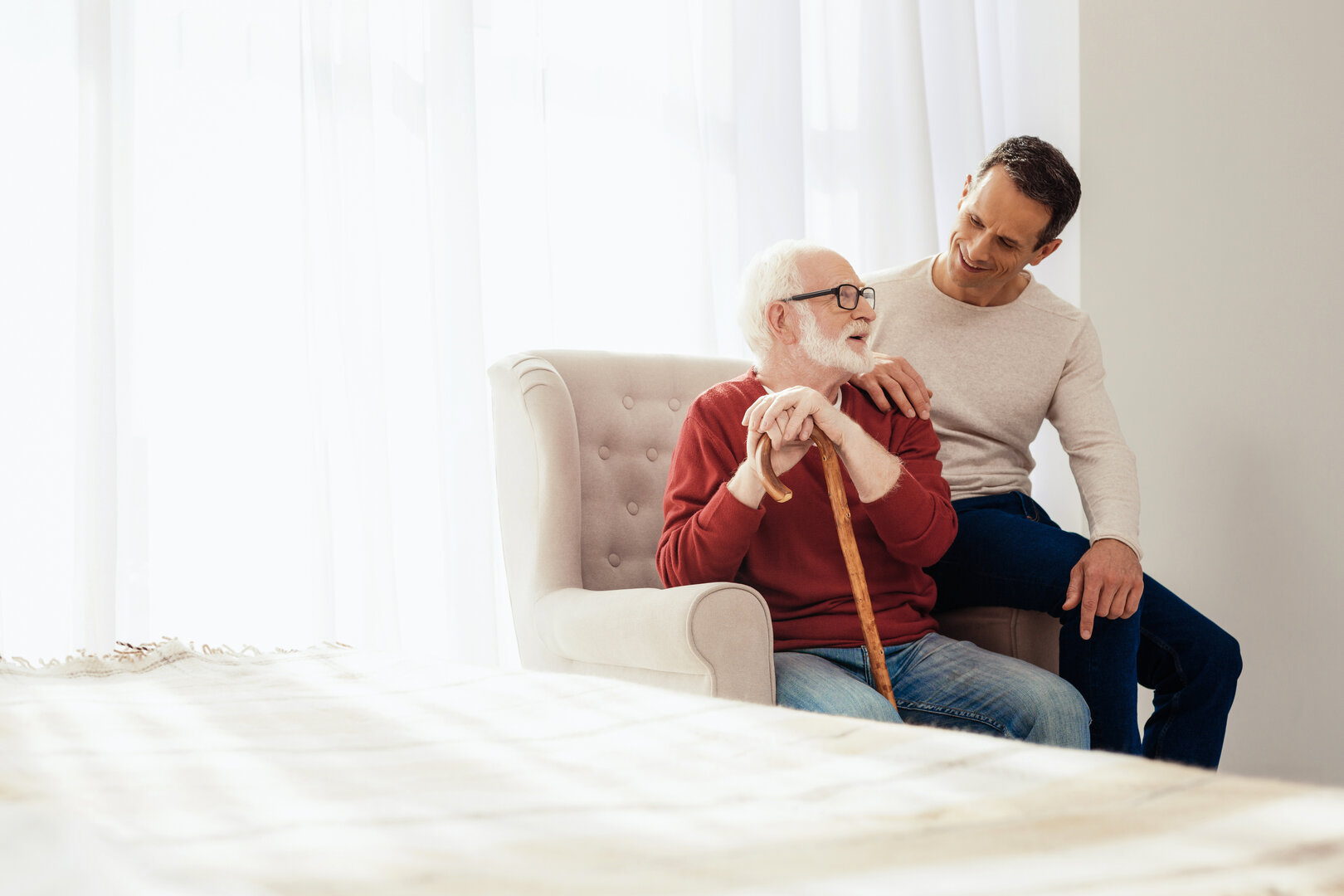 Carer providing companionship to elderly gentleman
